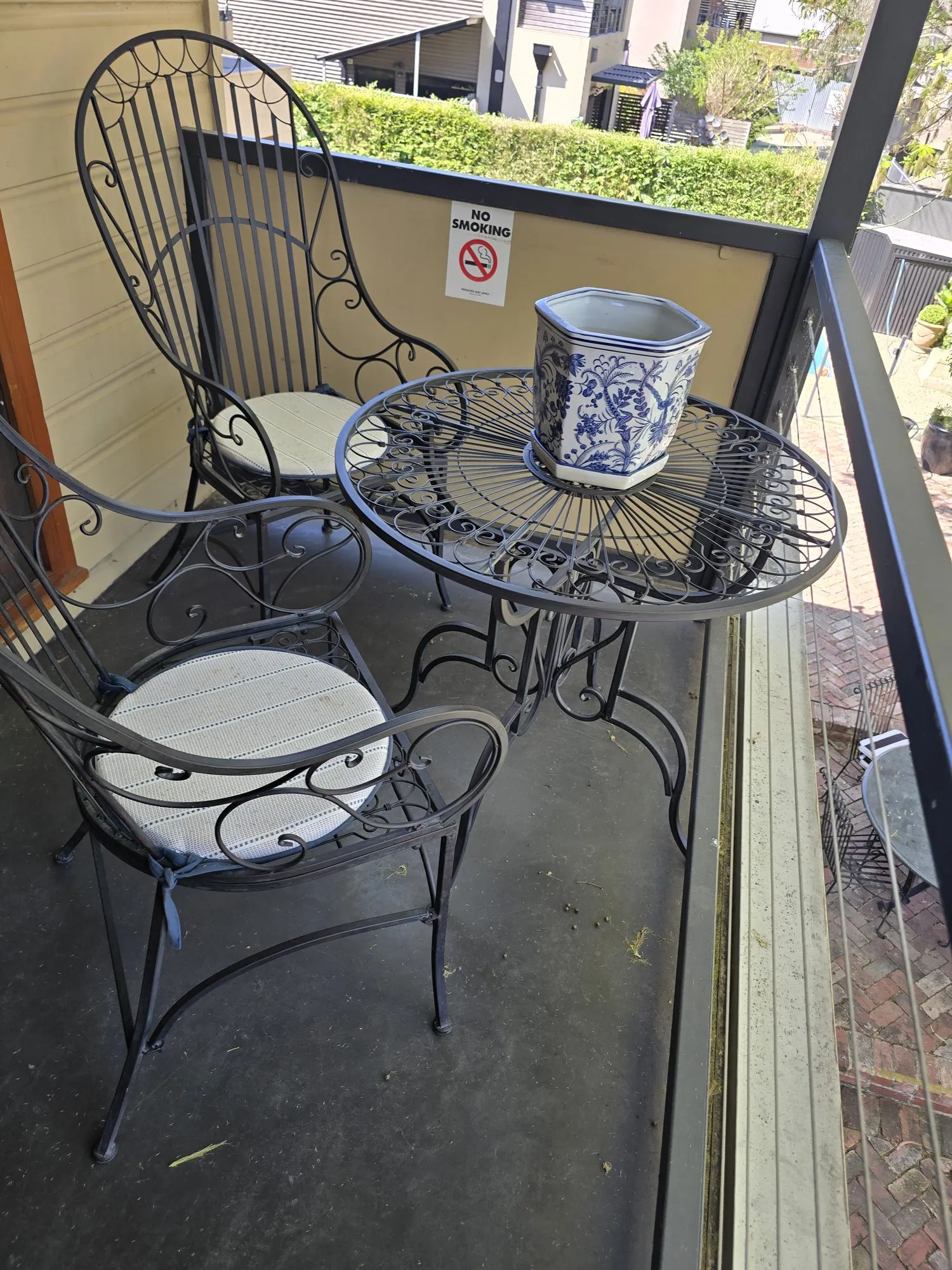 Wrought-iron table and chairs on the balcony overlooking the courtyard