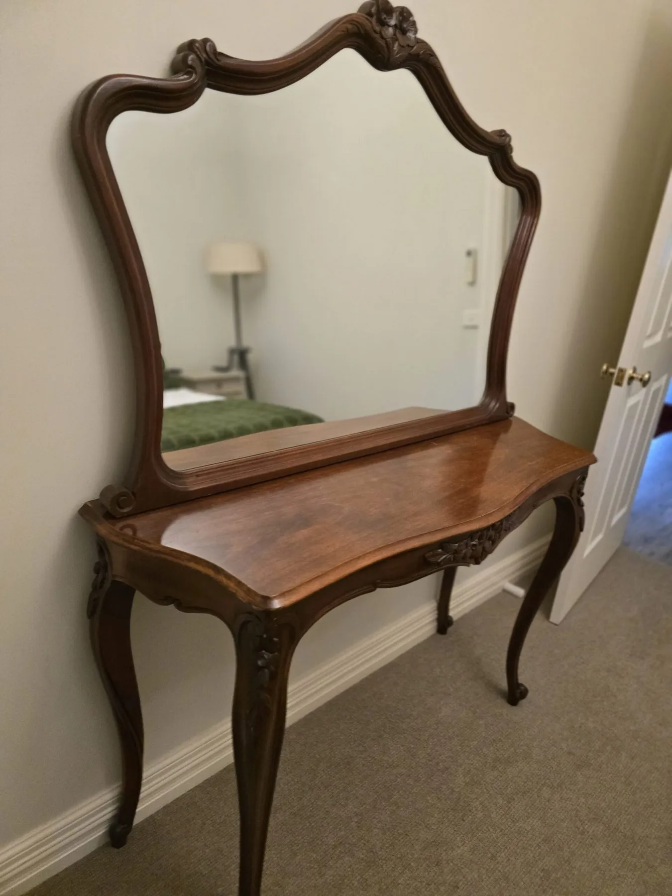 Carved antique console with a gilt-framed mirror