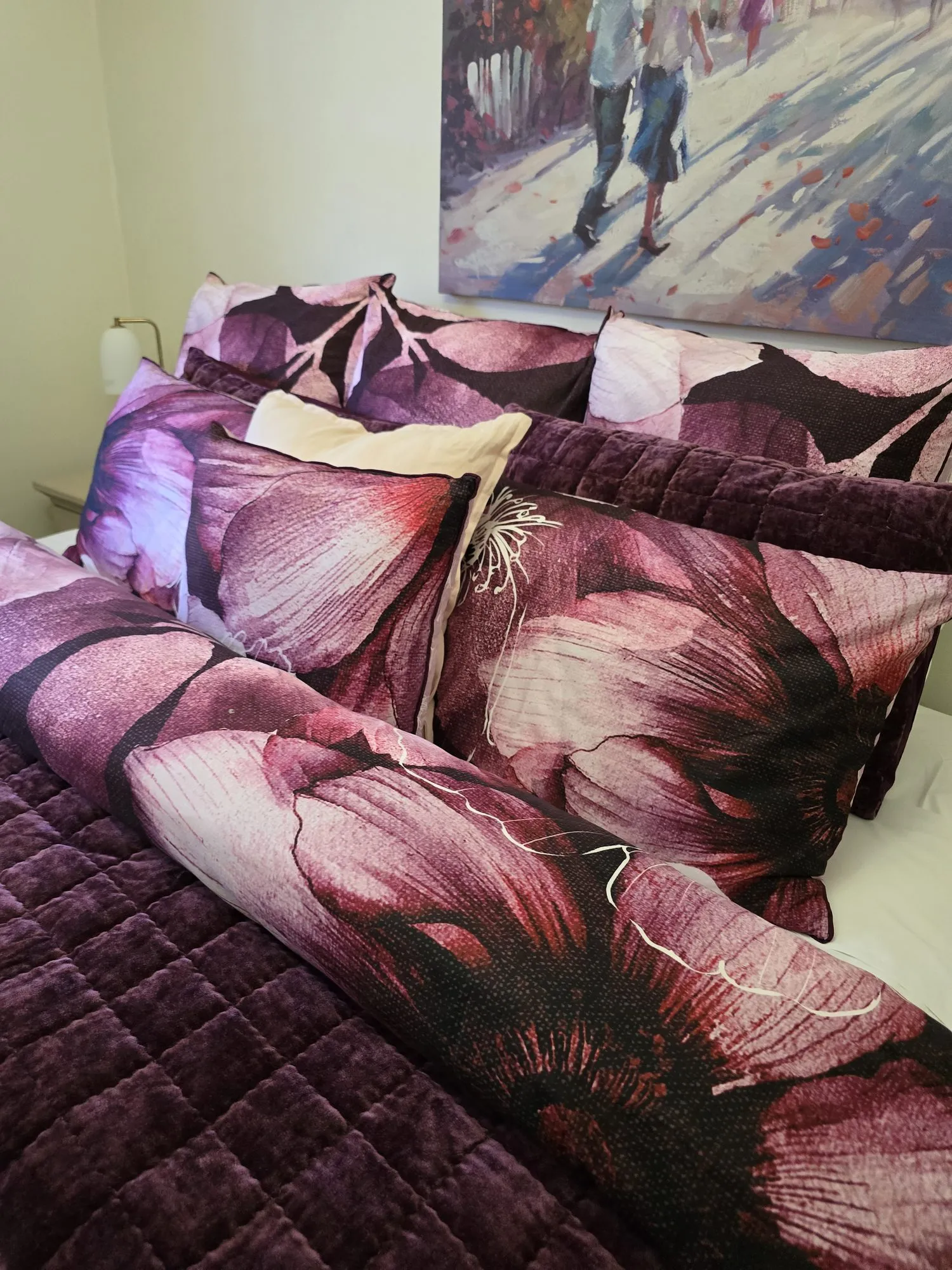 Close-up of the floral bedding and quilted velvet throw
