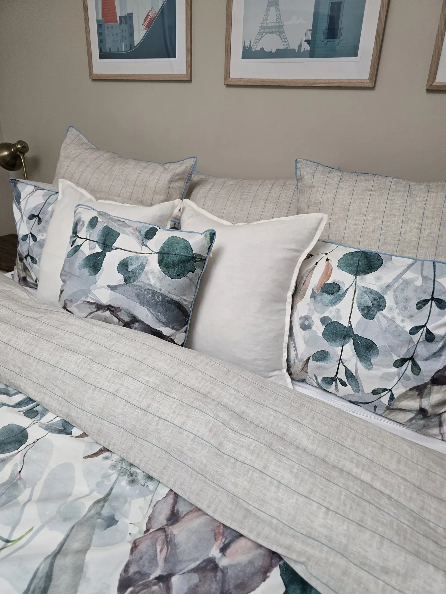 Eucalyptus-print cushions and striped linen on the main bed